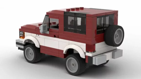 LEGO Ford Bronco II 89 scale model in two tone dark red and white color scheme on white background rear view angle